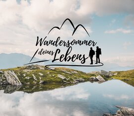 Mountain lake with hikers and the tagline ‘The hiking summer of your life’. | © Hohe Tauern National Park holiday region - Gerald Demolsky