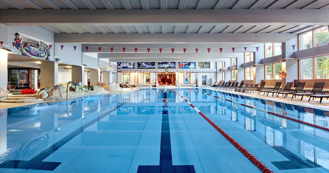 Modernes Hallenbad mit Schwimmbahnen und Liegestühlen. | © Hallenbad Kogler Mittersill