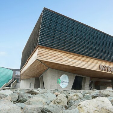  National Park Center with modern wood and concrete architecture and "360°" building in the background. | © Harry Liebmann