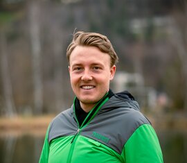 Lächelnder Mitarbeiter von der Nationalparkverwaltung Hohe Tauern in Salzburg in Nationalparkjacke am See. | © NPHT / Kreidl & Glück