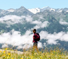 Hiker enjoying the view of majestic Alps and surrounding green valleys. | © Holiday Region National Park Hohe Tauern